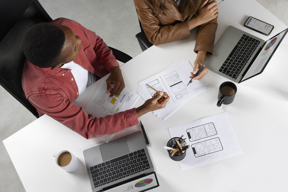 top-view-people-working-with-laptops